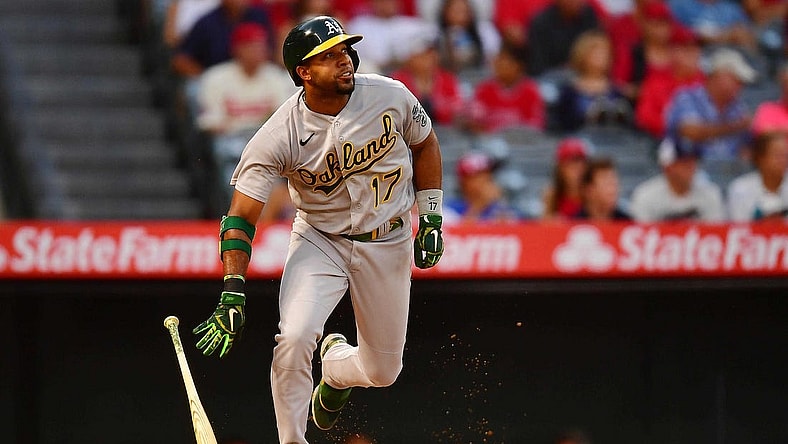 Aug 2, 2022; Anaheim, California, USA; Oakland Athletics shortstop Elvis Andrus (17) hits a single against the Los Angeles Angels during the fourth inning at Angel Stadium. Mandatory Credit: Gary A. Vasquez-USA TODAY Sports