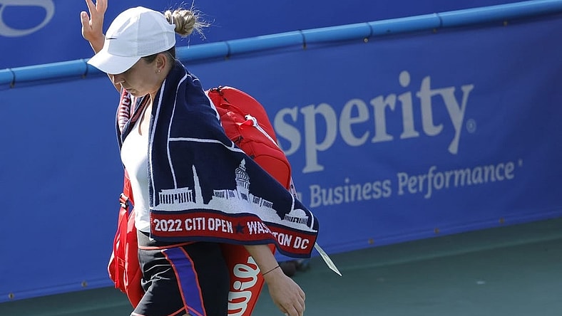 Aug 3, 2022; Washington, DC, USA; Simona Halep (ROU) waves to the crowd while leaving the court after retiring from her match against Anna Kaliskaya (not pictured) on day three of the Citi Open at Rock Creek Park Tennis Center. Mandatory Credit: Geoff Burke-USA TODAY Sports