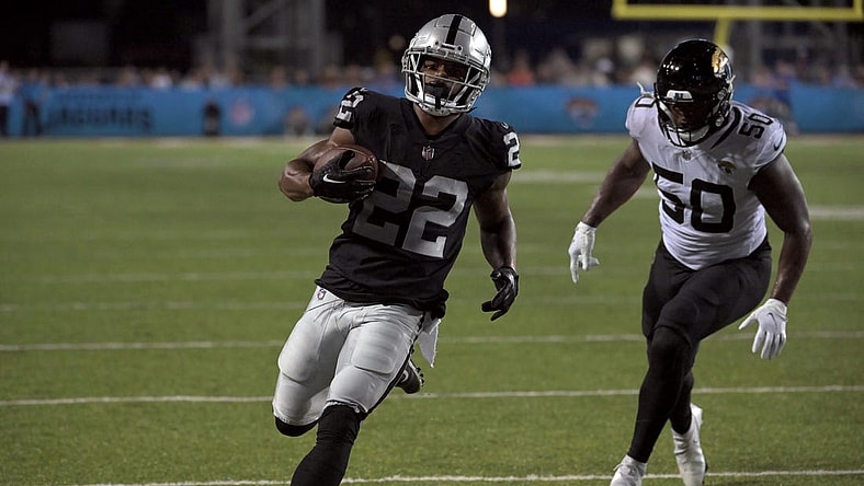 Aug 4, 2022; Canton, Ohio, USA; Las Vegas Raiders running back Ameer Abdullah (22) runs for a touchdown against Jacksonville Jaguars linebacker Shaquille Quarterman (50) in the second quarter in the Hall of Fame game at Tom Benson Hall of Fame Stadium. Mandatory Credit: Ken Blaze-USA TODAY Sports