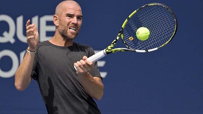 Aug 10, 2022; Montreal, QC, Canada; Adrian Mannarino (FRA) hits a forehand against Jannik Sinner (ITA) (not pictured) in second round play at IGA Stadium. Mandatory Credit: Eric Bolte-USA TODAY Sports