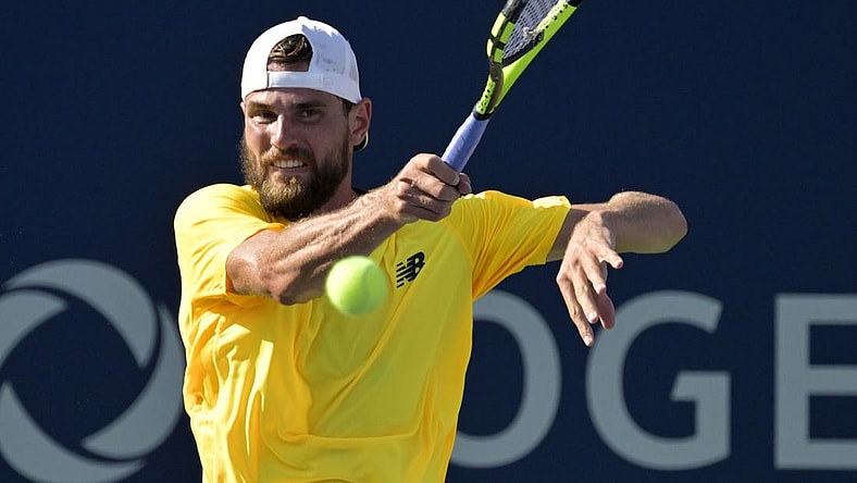 Aug 10, 2022; Montreal, QC, Canada; Maxime Cressy (USA) hits a forehand against Gael Monfils (FRA) (not pictured) in second round play at IGA Stadium. Mandatory Credit: Eric Bolte-USA TODAY Sports