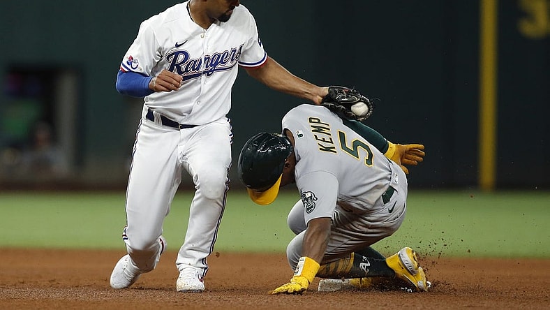 Aug 15, 2022; Arlington, Texas, USA; Oakland Athletics left fielder Tony Kemp (5) steals second base in the fifth inning as Texas Rangers second baseman Marcus Semien (2) applies the tag at Globe Life Field. Mandatory Credit: Tim Heitman-USA TODAY Sports