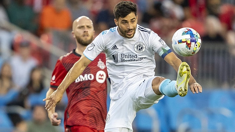 Aug 17, 2022; Toronto, Ontario, CAN; New England Revolution midfielder Carles Gil (10) attempts to control the ball against Toronto FC midfielder Michael Bradley (4) during the first half at BMO Field. Mandatory Credit: Kevin Sousa-USA TODAY Sports