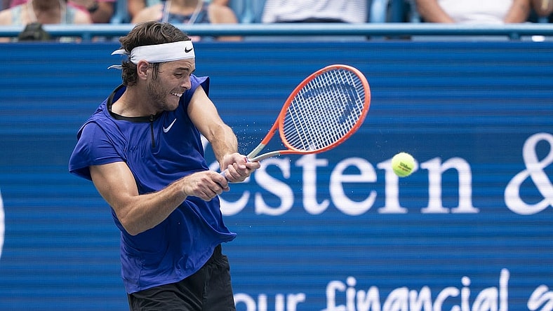 Aug 19, 2022; Cincinnati, OH, USA; Taylor Fritz (USA) returns a shot during his match against Daniil Medvedev (RUS) at the Western & Southern Open at the Lindner Family Tennis Center. Mandatory Credit: Susan Mullane-USA TODAY Sports