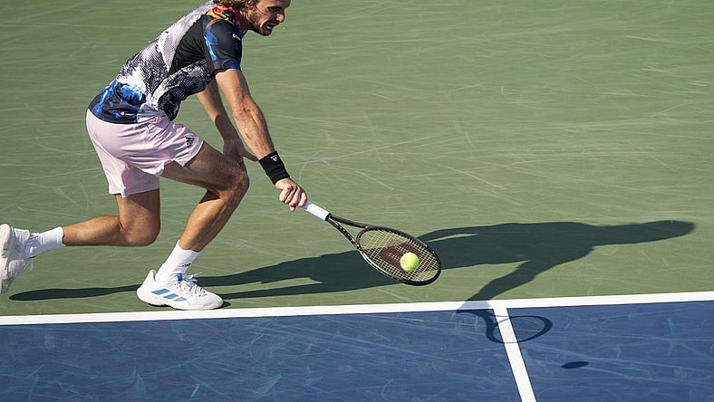 Aug 19, 2022; Cincinnati, OH, USA; Stefanos Tsitsipas (GRE) returns a shot during his match against John Isner (USA) at the Western & Southern Open at the Lindner Family Tennis Center. Mandatory Credit: Susan Mullane-USA TODAY Sports