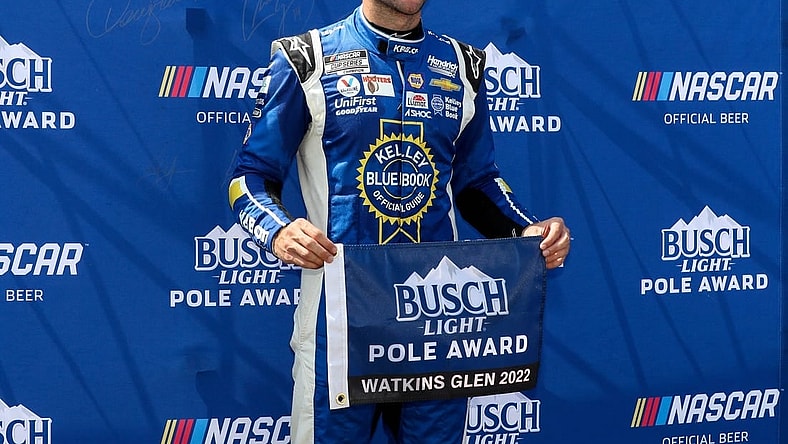Aug 20, 2022; Watkins Glen, New York, USA; NASCAR Cup Series driver Chase Elliott stands with the pole award after winning the pole during practice and qualifying for the Go Bowling at The Glen at Watkins Glen International. Mandatory Credit: Matthew OHaren-USA TODAY Sports