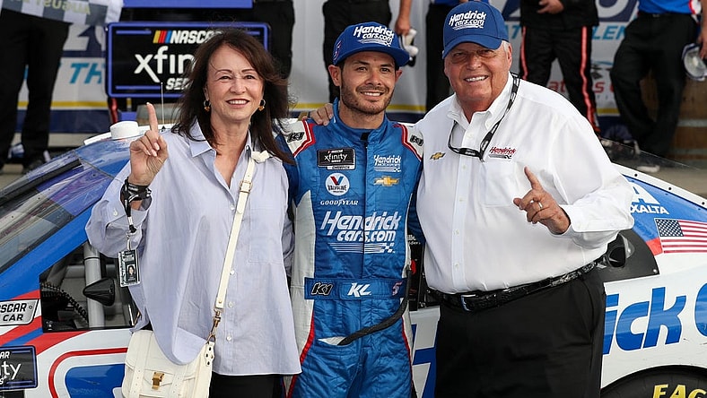 Aug 20, 2022; Watkins Glen, New York, USA; NASCAR Xfinity Series driver Kyle Larson celebrates with owner Rick Hendrick (right) and his wife Linda Hendrick (left) in victory lane after winning the Sunoco Go Rewards 200 at Watkins Glen International. Mandatory Credit: Matthew OHaren-USA TODAY Sports