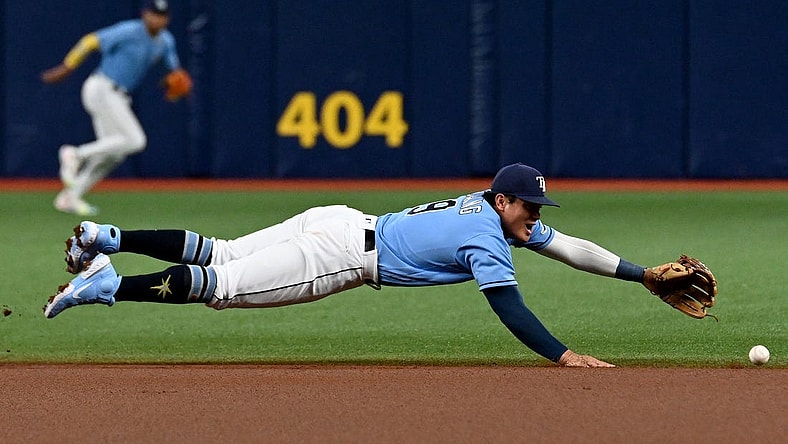 Aug 22, 2022; St. Petersburg, Florida, USA;  Tampa Bay Rays second baseman Yu Chang (9) dives for a ground ball in the first inning against the Los Angeles Angels  at Tropicana Field. Mandatory Credit: Jonathan Dyer-USA TODAY Sports