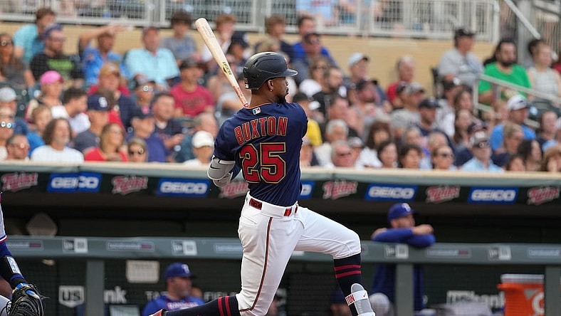 Aug 22, 2022; Minneapolis, Minnesota, USA; Minnesota Twins center fielder Byron Buxton (25) hits a single during the third inning against the Texas Rangers at Target Field. Mandatory Credit: Jordan Johnson-USA TODAY Sports