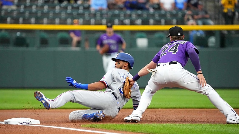 Aug 23, 2022; Denver, Colorado, USA; Colorado Rockies third baseman Ryan McMahon (24) tags out Texas Rangers center fielder Leody Taveras (3) in the first inning at Coors Field. Mandatory Credit: Ron Chenoy-USA TODAY Sports