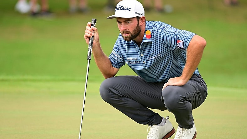 Aug 25, 2022; Atlanta, Georgia, USA; Cameron Young lines a putt on the 1st green during the first round of the TOUR Championship golf tournament. Mandatory Credit: Adam Hagy-USA TODAY Sports