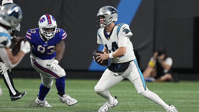 Aug 26, 2022; Charlotte, North Carolina, USA; Carolina Panthers quarterback Sam Darnold (14) is forced from the pocket by the Buffalo Bills defense during the second quarter at Bank of America Stadium. Mandatory Credit: Jim Dedmon-USA TODAY Sports
