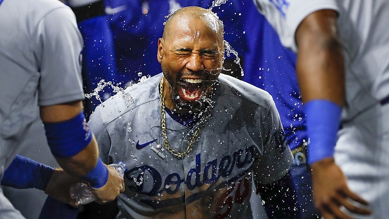 Aug 26, 2022; Miami, Florida, USA; Los Angeles Dodgers right fielder Mookie Betts (50) celebrates as third baseman Justin Turner (10) and second baseman Hanser Alberto (17) pour water over his head after hitting a two-run home run during the seventh inning against the Miami Marlins at loanDepot Park. Mandatory Credit: Sam Navarro-USA TODAY Sports