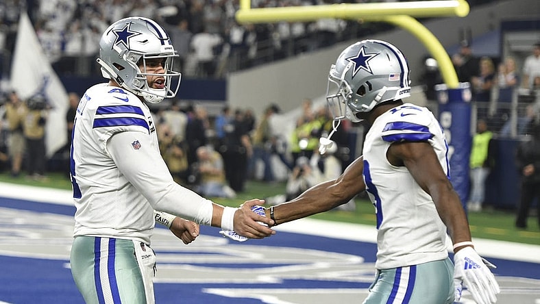 Jan 5, 2019; Arlington, TX, USA; Dallas Cowboys quarterback Dak Prescott (4) reacts after throwing a 11 yard touchdown pass to wide receiver Michael Gallup (13) against the Seattle Seahawks in the second quarter in a NFC Wild Card playoff football game at AT&T Stadium. Mandatory Credit: Shane Roper-USA TODAY Sports