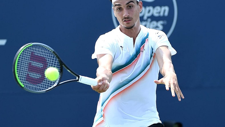 Aug 9, 2021; Toronto, Ontario, Canada; Lorenzo Sonego of Italy plays a shot against Ugo Humbert of France in first round play at Aviva Centre. Mandatory Credit: Dan Hamilton-USA TODAY Sports