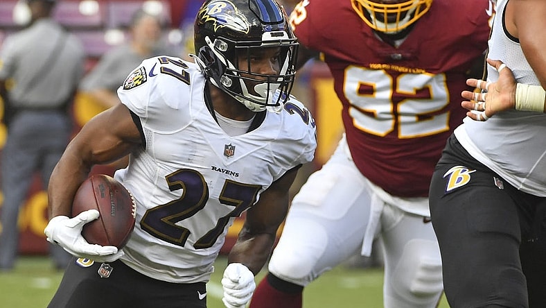 Aug 28, 2021; Landover, Maryland, USA; Baltimore Ravens running back J.K. Dobbins (27) carries the ball against the Washington Football Team during the first quarter at FedExField. Mandatory Credit: Brad Mills-USA TODAY Sports