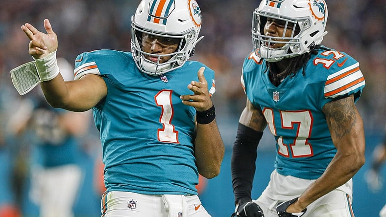 Jan 9, 2022; Miami Gardens, Florida, USA; Miami Dolphins quarterback Tua Tagovailoa (1) reacts with wide receiver Jaylen Waddle (17) after running with the football for a first down against the New England Patriots during the fourth quarter at Hard Rock Stadium. Mandatory Credit: Sam Navarro-USA TODAY Sports