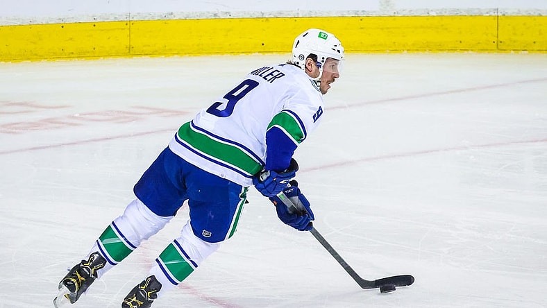 Apr 23, 2022; Calgary, Alberta, CAN; Vancouver Canucks center J.T. Miller (9) skates with the puck against the Calgary Flames during the first period at Scotiabank Saddledome. Mandatory Credit: Sergei Belski-USA TODAY Sports
