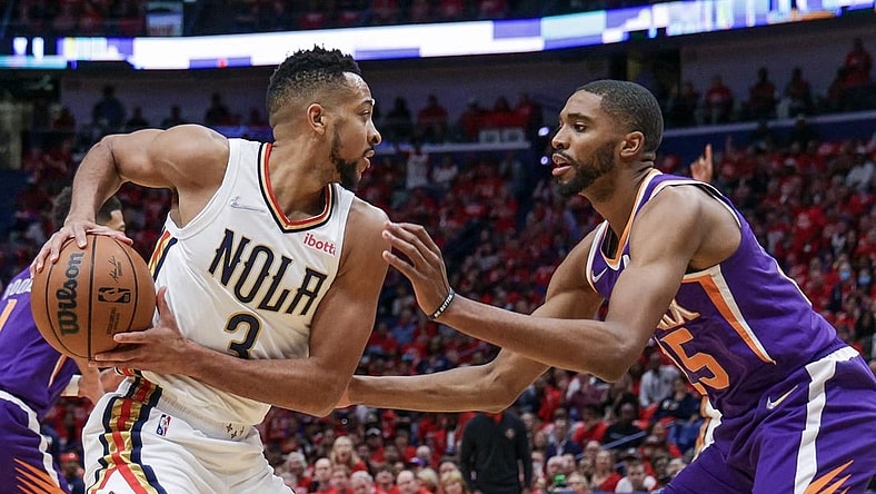 Apr 28, 2022; New Orleans, Louisiana, USA;  New Orleans Pelicans guard CJ McCollum (3) is defended by Phoenix Suns forward Mikal Bridges (25) during the first half of game six of the first round for the 2022 NBA playoffs at Smoothie King Center. Mandatory Credit: Stephen Lew-USA TODAY Sports
