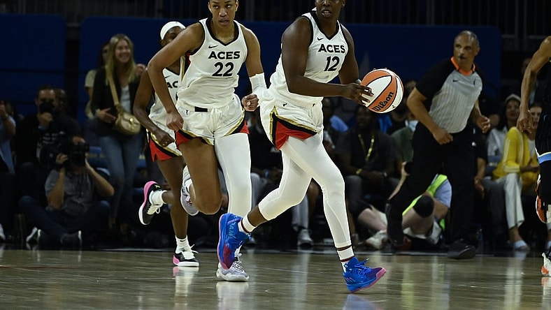 Jul 26, 2022; Chicago, IL, USA;  Las Vegas Aces guard Chelsea Gray (12) moves the ball with Las Vegas Aces forward A'ja Wilson (22) against the Chicago Sky during the second half of the Commissioners Cup-Championships at Wintrust Arena. Mandatory Credit: Matt Marton-USA TODAY Sports