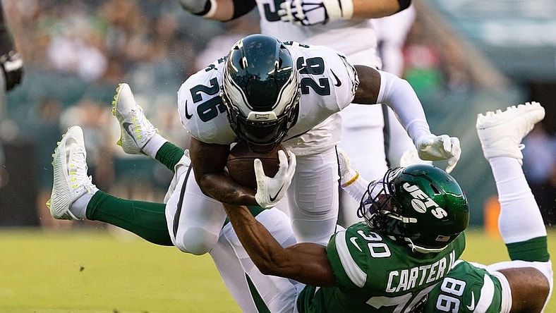 Aug 12, 2022; Philadelphia, Pennsylvania, USA; New York Jets cornerback Michael Carter II (30) tackles Philadelphia Eagles running back Miles Sanders (26) during the first quarter at Lincoln Financial Field. Mandatory Credit: Bill Streicher-USA TODAY Sports