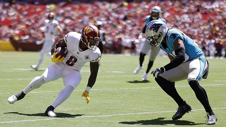 Aug 13, 2022; Landover, Maryland, USA; Washington Commanders running back Brian Robinson (8) runs with the ball as Carolina Panthers cornerback Chris Westry (39) defends during the second quarter at FedExField. Mandatory Credit: Geoff Burke-USA TODAY Sports