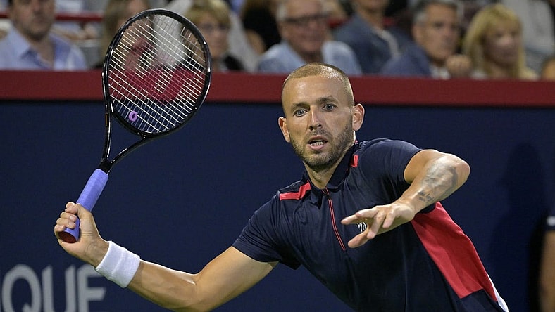 Aug 13, 2022; Montreal, QC, Canada; Daniel Evans (GBR) hits a forehand against Pablo Carreno Busta (ESP) (not pictured) in semifinal play in the National Bank Open at IGA Stadium. Mandatory Credit: Eric Bolte-USA TODAY Sports