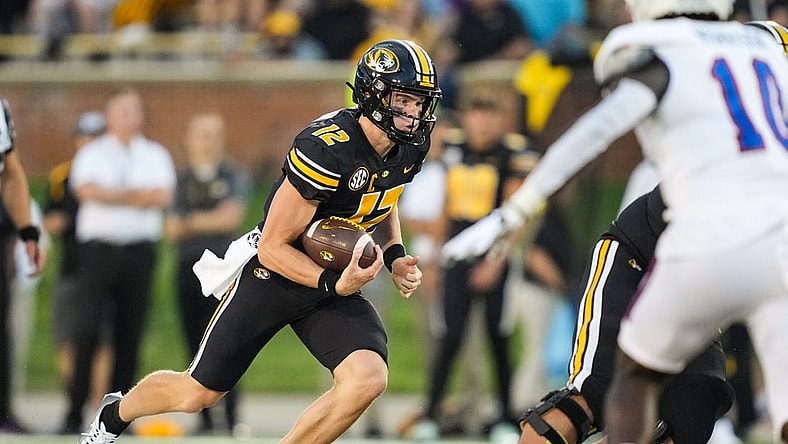 Sep 1, 2022; Columbia, Missouri, USA; Missouri Tigers quarterback Brady Cook (12) runs the ball against the Louisiana Tech Bulldogs during the first half at Faurot Field at Memorial Stadium. Mandatory Credit: Jay Biggerstaff-USA TODAY Sports