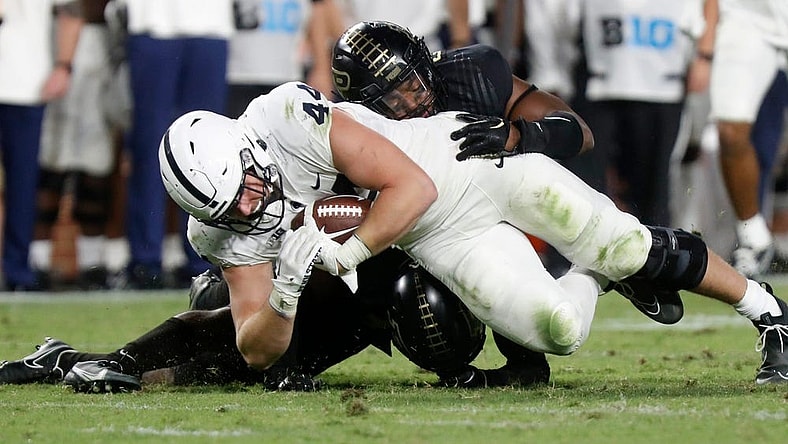 Purdue Boilermakers linebacker Clyde Washington (42) and Purdue Boilermakers safety Chris Jefferson (17) tackle Penn State Nittany Lions tight end Tyler Warren (44) during the NCAA football game, Thursday, Sept. 1, 2022, at Ross-Ade Stadium in West Lafayette, Ind. Penn State won 35-31.

Purduepennstatefb090122 Am01374