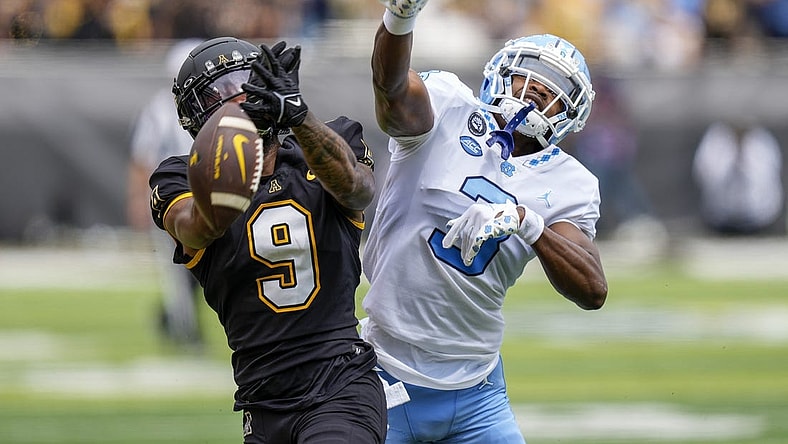 Sep 3, 2022; Boone, North Carolina, USA;Appalachian State Mountaineers wide receiver Christian Wells (9) cannot catch a pass while defended by North Carolina Tar Heels defensive back Storm Duck (3) during the first quarter at Kidd Brewer Stadium. Mandatory Credit: Jim Dedmon-USA TODAY Sports