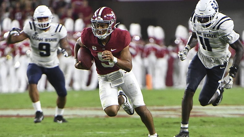 Sep 3, 2022; Tuscaloosa, Alabama, USA;  Alabama Crimson Tide quarterback Bryce Young (9) outruns Utah State defensive lineman Daniel Grzesiak (9) and Utah State defensive lineman Byron Vaughns (11) at Bryant-Denny Stadium. Mandatory Credit: Gary Cosby Jr.-USA TODAY Sports