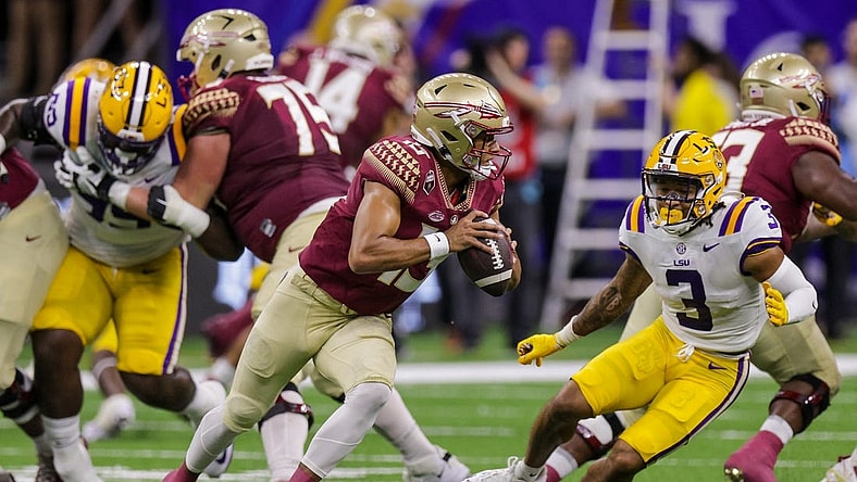 Sep 4, 2022; New Orleans, Louisiana, USA; Florida State Seminoles quarterback Jordan Travis (13) scrambles away from LSU Tigers safety Greg Brooks Jr. (3) during the first half of the game at Caesars Superdome. Mandatory Credit: Stephen Lew-USA TODAY Sports