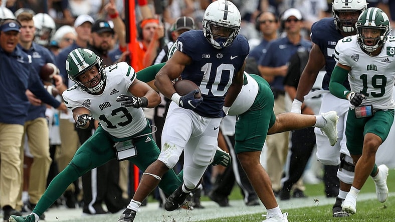 Sep 10, 2022; University Park, Pennsylvania, USA; Penn State Nittany Lions running back Nicholas Singleton (10) avoids a tackle while running with the ball during the first quarter against the Ohio Bobcats at Beaver Stadium. Mandatory Credit: Matthew OHaren-USA TODAY Sports