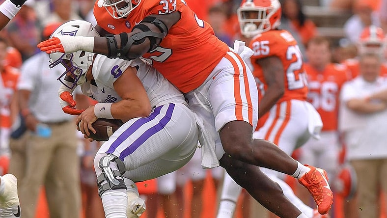 Sep 10, 2022; Clemson, South Carolina, USA;  Clemson Tigers defensive tackle Ruke Orhorhoro (33) tackles Furman Paladins quarterback Tyler Huff (6) during the first quarter at Memorial Stadium. Mandatory Credit: Ken Ruinard-USA TODAY Sports