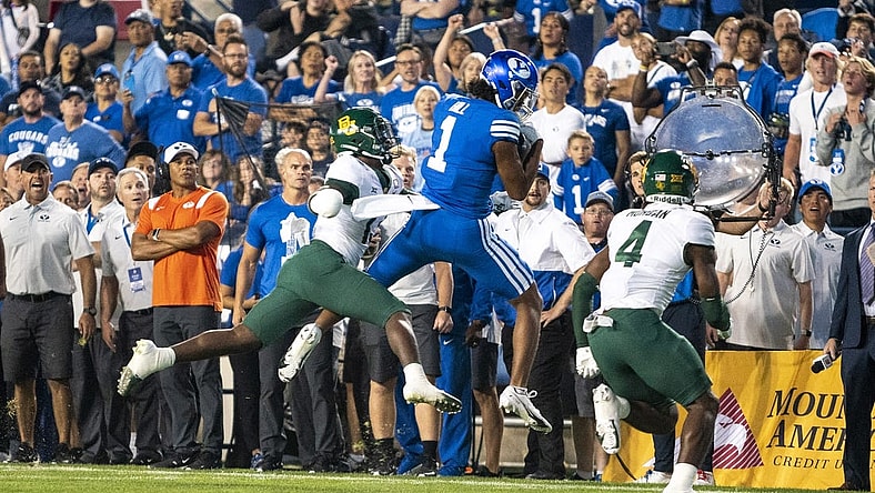Sep 10, 2022; Provo, Utah, USA; Brigham Young Cougars wide receiver Keanu Hill (1) catches a pass against Baylor Bears safety Al Walcott (13) and safety Christian Morgan (4) in the first half at LaVell Edwards Stadium. Mandatory Credit: Gabriel Mayberry-USA TODAY Sports