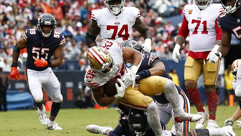Sep 11, 2022; Chicago, Illinois, USA; San Francisco 49ers running back Elijah Mitchell (25) rushes the ball against Chicago Bears safety Jaquan Brisker (9) during the first half at Soldier Field. Mandatory Credit: Mike Dinovo-USA TODAY Sports
