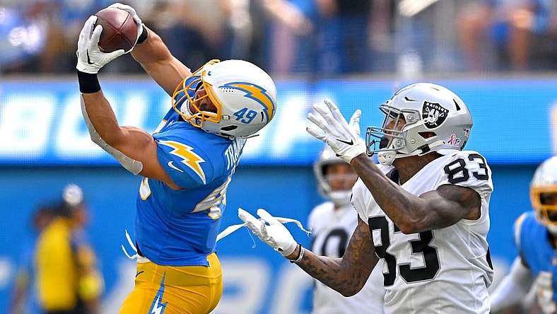 Sep 11, 2022; Inglewood, California, USA; Los Angeles Chargers linebacker Drue Tranquill (49) intercepts a pass intended for Las Vegas Raiders tight end Darren Waller (83) in the second quarter at SoFi Stadium. Mandatory Credit: Jayne Kamin-Oncea-USA TODAY Sports