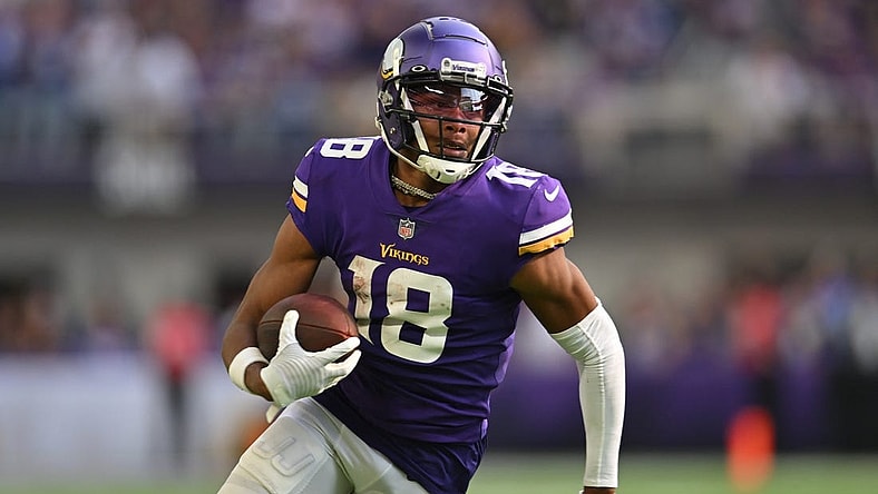 Sep 11, 2022; Minneapolis, Minnesota, USA; Minnesota Vikings wide receiver Justin Jefferson (18) scores a touchdown on a pass from quarterback Kirk Cousins (not pictured) against the Green Bay Packers during the second quarter at U.S. Bank Stadium. Mandatory Credit: Jeffrey Becker-USA TODAY Sports