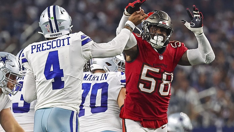 Sep 11, 2022; Arlington, Texas, USA;  Dallas Cowboys quarterback Dak Prescott (4) hits his hand against Tampa Bay Buccaneers linebacker Shaquil Barrett (58) as he throws the ball during the fourth quarter at AT&T Stadium. Mandatory Credit: Kevin Jairaj-USA TODAY Sports