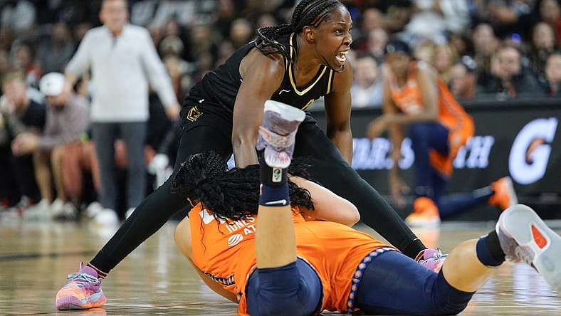 Sep 13, 2022; Las Vegas, Nevada, USA; Las Vegas Aces guard Chelsea Gray (12) reacts to being fouled by Connecticut Sun forward Brionna Jones (42) during the second quarter in game two of the WNBA Finals at Michelob Ultra Arena. Mandatory Credit: Lucas Peltier-USA TODAY Sports