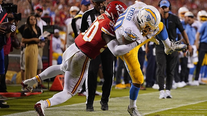 Sep 15, 2022; Kansas City, Missouri, USA; Los Angeles Chargers running back Austin Ekeler (30) is brought down by Kansas City Chiefs linebacker Willie Gay (50) during the second half at GEHA Field at Arrowhead Stadium. Mandatory Credit: Jay Biggerstaff-USA TODAY Sports