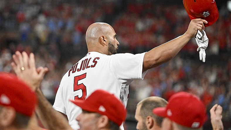 Sep 16, 2022; St. Louis, Missouri, USA;  St. Louis Cardinals designated hitter Albert Pujols (5) salutes the fans as he receives a standing ovation after hitting a game tying two run home run for his 698th career home run during the sixth inning against the Cincinnati Reds at Busch Stadium. Mandatory Credit: Jeff Curry-USA TODAY Sports
