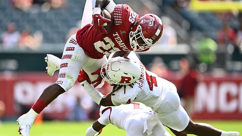 Sep 17, 2022; Philadelphia, Pennsylvania, USA; Rutgers Scarlet Knights defensive back Desmond Igbinosun (4) tackles Temple Owls running back Edward Saydee (23) in the first half at Lincoln Financial Field. Mandatory Credit: Kyle Ross-USA TODAY Sports