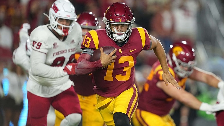 Sep 17, 2022; Los Angeles, California, USA; Southern California Trojans quarterback Caleb Williams (13) carries the ball against the Fresno State Bulldogs] in the first half at United Airlines Field at Los Angeles Memorial Coliseum. Mandatory Credit: Kirby Lee-USA TODAY Sports