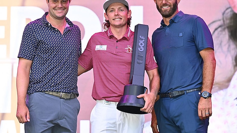 Sep 18, 2022; Chicago, Illinois, USA; Cameron Smith holds the winning trophy while posing with runner up Peter Uihlein, far left, and third place finisher Dustin Johnson after the final round of the Invitational Chicago LIV Golf tournament at Rich Harvest Farms. Mandatory Credit: Jamie Sabau-USA TODAY Sports