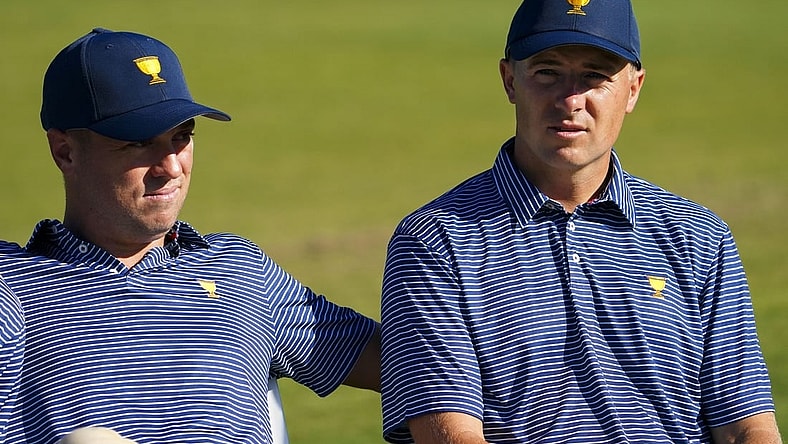 Sep 21, 2022; Charlotte, North Carolina, USA; Team USA golfer Justin Thomas (left) and Team USA golfer Jordan Spieth (right) sit before the team photo during a practice day for the Presidents Cup golf tournament at Quail Hollow Club. Mandatory Credit: Peter Casey-USA TODAY Sports