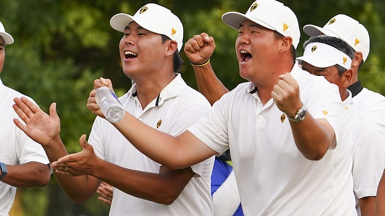Sep 24, 2022; Charlotte, North Carolina, USA; International Team golfer Si Woo Kim (left) and golfer Sungjae Im (right) celebrate on the 18th green during the four-ball match play of the Presidents Cup golf tournament at Quail Hollow Club. Mandatory Credit: Peter Casey-USA TODAY Sports