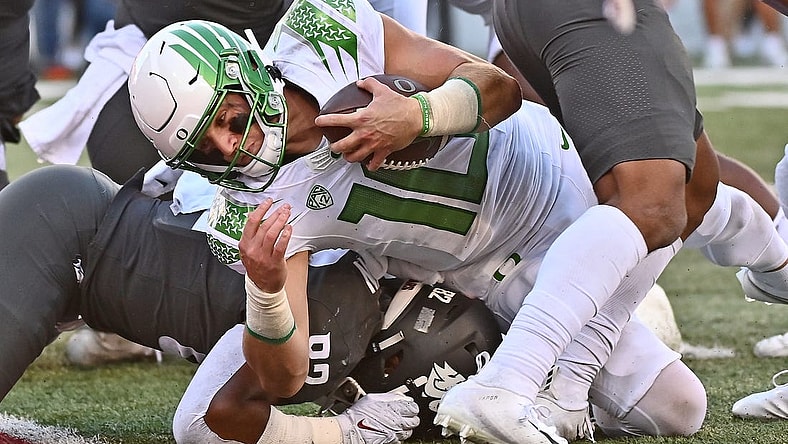 Sep 24, 2022; Pullman, Washington, USA; Oregon Ducks quarterback Bo Nix (10) is stopped short of the goalie by Washington State Cougars linebacker Travion Brown (82) in the second half at Gesa Field at Martin Stadium. Ducks won 44-41. Mandatory Credit: James Snook-USA TODAY Sports