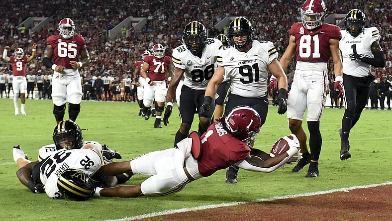 Sep 24, 2022; Tuscaloosa, Alabama, USA;  Alabama Crimson Tide running back Jahmyr Gibbs (1) stretches across the goal line for a touchdown against Vanderbilt Commodores linebacker Ethan Barr (32) at Bryant-Denny Stadium. Mandatory Credit: Gary Cosby Jr.-USA TODAY Sports