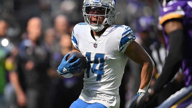 Sep 25, 2022; Minneapolis, Minnesota, USA; Detroit Lions wide receiver Amon-Ra St. Brown (14) runs the ball after a catch from quarterback Jared Goff (not pictured) against the Minnesota Vikings during the first quarter at U.S. Bank Stadium. Mandatory Credit: Jeffrey Becker-USA TODAY Sports